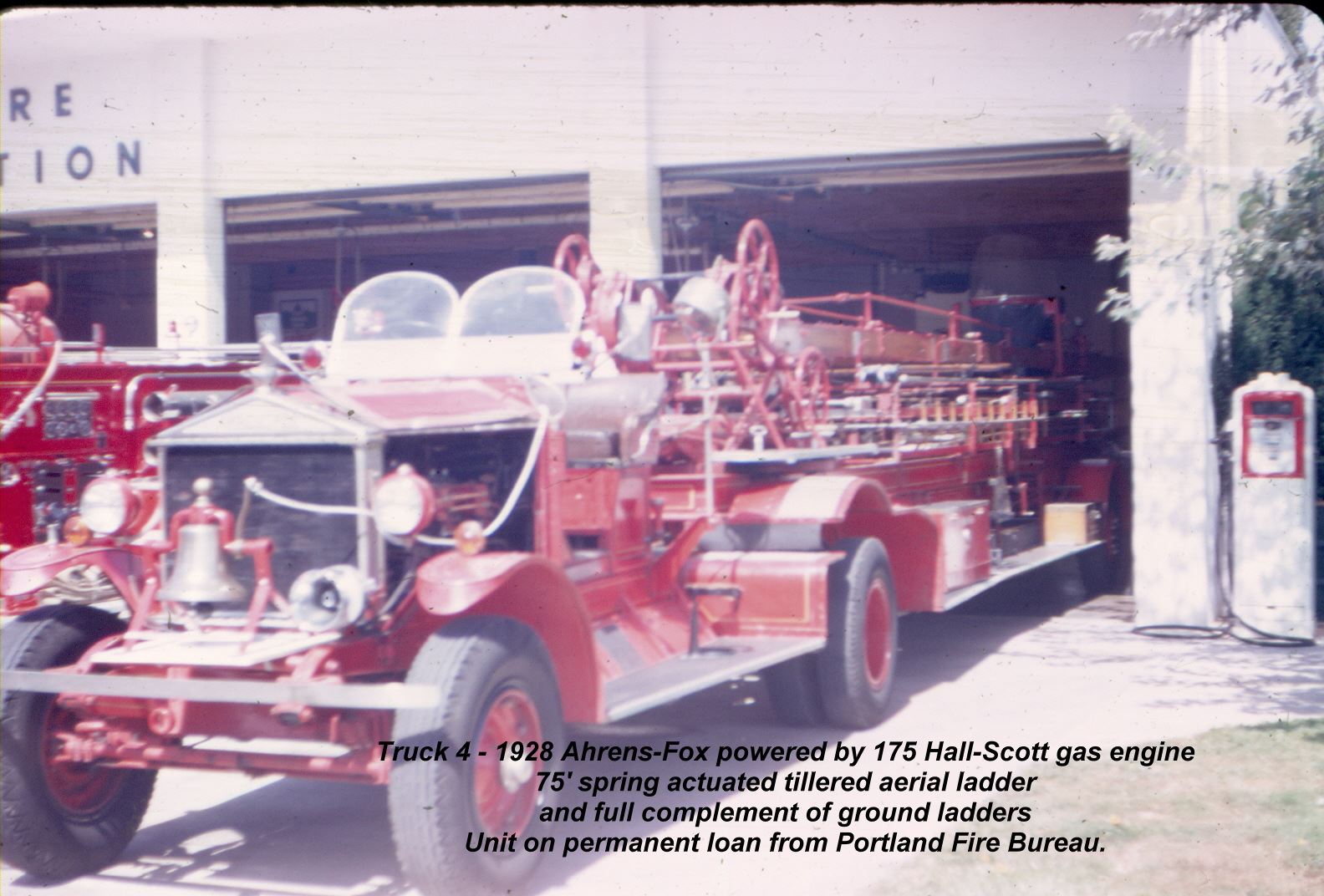 1928 Ahrens-Fox-powered Beaverton Fire Department ladder truck parked in front of station